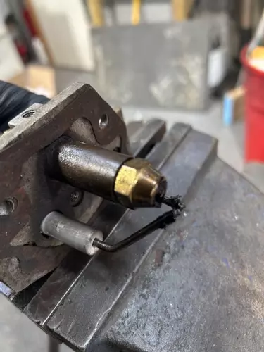 Old and worn burner electrodes on Edge Panther pressure washer showing carbon buildup prior to replacement.